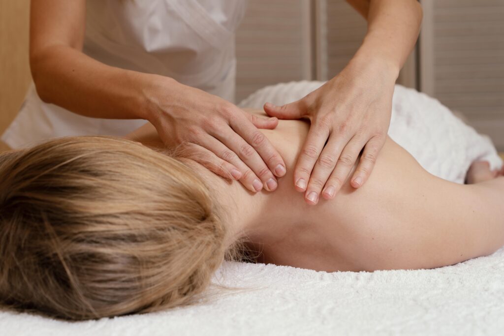 close up hands massaging woman s back